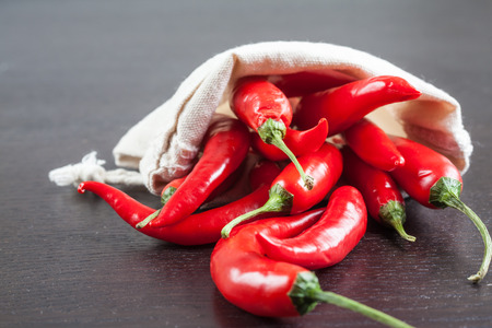 Hot fresh chili coming out from a bag.の写真素材