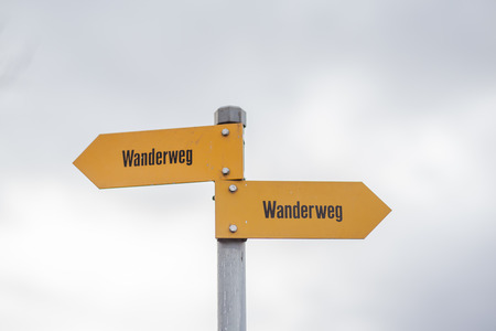 Sign post of swiss alps indicating the hiking trails (Wanderweg)の写真素材
