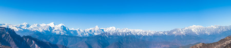 Panorama view of the mountain range including Minya Konka (7556m) from top of cattle back mountain in the morning, Sichuan Province, Chinaの写真素材
