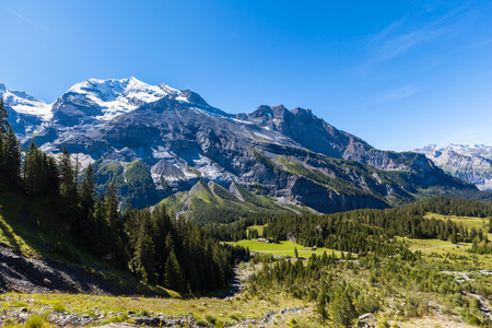 Stunning view of Bluemlisalp and Frundenhorn above Oeschinensee Oeschinen lake swiss alps on Bernese Oberland. Photo taken in summer on the hiking path at the lake side Switzerlandの写真素材