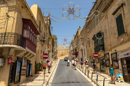 Victoria, Malta - August 3, 2019 -  Tourists heading towards the citadel of Victoria (Cittadella) on...