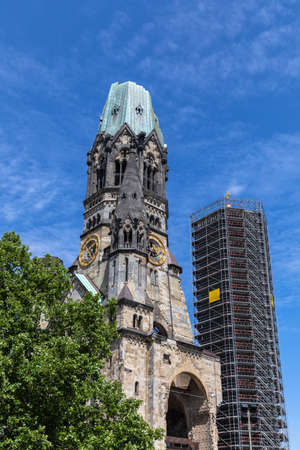Close view of the Kaiser Wilhelm Memorial Church in Berlin on a sunny summer day, a famous landmark in western Berlin, Germany. With the modern belfry in renovation.の写真素材