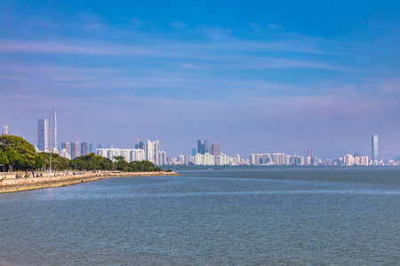Skyline of Shenzhen city from the Shenzhen bay park, the first Special Economic Zone of China, with skyscrapers and  cloudscape on a sunny day, Guangdong Province, Chinaの写真素材