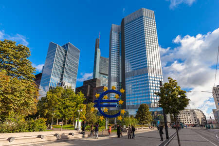 Frankfurt am Main, Germany - October 2, 2016 - Tourists taking photo of the huge sculpture of the Euro sign in front of the European Central Bank headquarter building in Franfurt am Main, Hesse, Germanyのeditorial素材