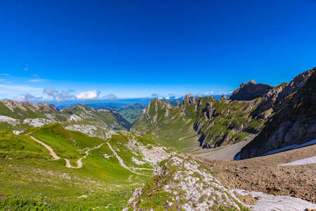 Stunning view of Alpstein Massif from Rotsteinpass, toward Wasserauen valley on the hiking trail to Santis (Saentis), Canton of St. Gallen, Appenzell, Switzerland.の写真素材