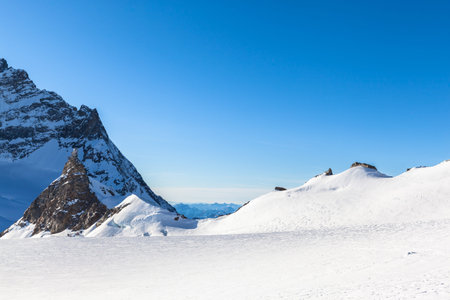 Stunning view of the famous peak Jungfrau of swiss Alpsand and the Sphinx Observatory, one of the...
