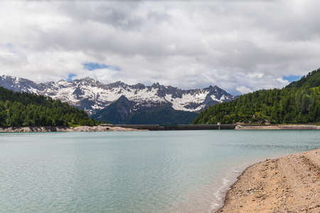 Panorama view of the lake of Ritom and the dam with the alps in background, Canton Ticino of Switzerland.の写真素材