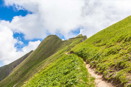 Hiking path along the mountain ridge on Bernese Oberland near Brienzer Rothorn above the Brienz lake in canton of Bern, Switzerland.の写真素材