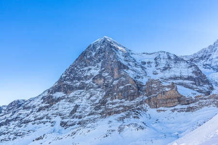 Stunning close up view of Eiger north face from Kleine Scheidegg on a winter sunny day, famous mountain of Swiss Alps on Bernese Oberland near Jungfrau, Interlaken, Switzerlandの写真素材