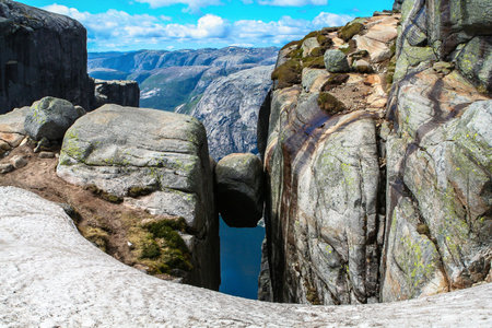 Close view of the famous boulder Kjeragbolten above the Lysefjorden on the mountain Kjerag in...