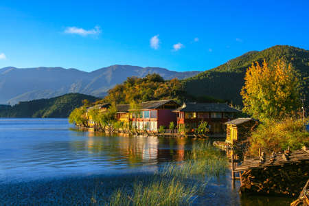 Peaceful view of the Lugu lake and the village in the morning sunshine, Yunnan Province, China.の写真素材