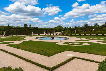 View of a corner of the garden after the Versailles Palace on a sunny day with clouds and blue sky, Paris, Franceのeditorial素材