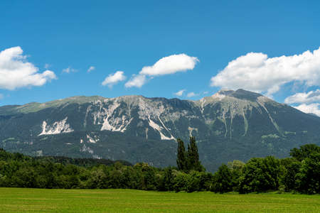 Beautiful panorama view of Veliki Stol (Hochstuhl) massif at border between Slovenia and Austria on a sunny summer day from Bled with blue sky cloud.の写真素材