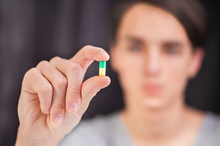 Pills in the hand. On a white background. Close-up.