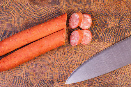 Sliced sausage on an oak board sharp. Kitchen knifeの写真素材