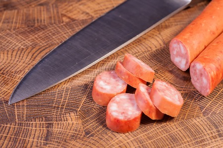 Sliced sausage on an oak board sharp. Kitchen knifeの写真素材