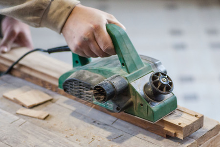 Manual manufacturing of furniture from a natural tree in a workshop.の写真素材