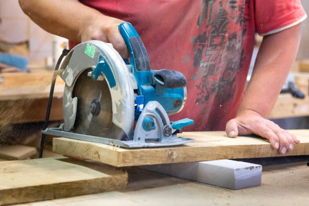 Manual manufacturing of furniture from a natural tree in a workshop.