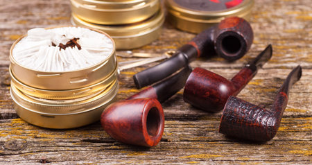 Vintage smoking pipes. Good expensive tobacco. Background of old boards