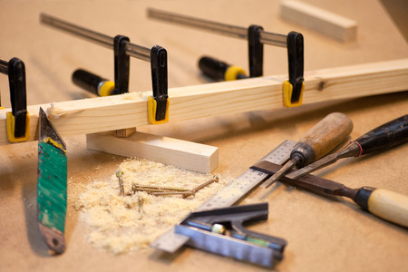 Manual manufacturing of furniture from a natural tree in a workshop.の写真素材