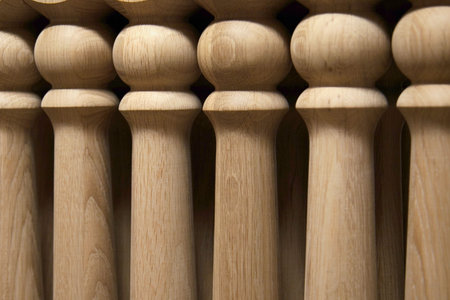 Elements of wooden stairs. Oak balusters. Production of wooden stairs. Close-up.