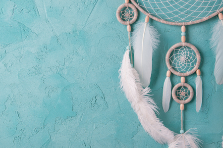 Mint cream dream catcher on turquoise textured background. Texture of concrete.の写真素材