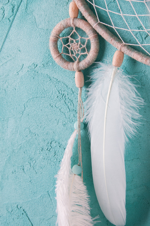 Mint cream dream catcher on turquoise textured background. Texture of concrete.の写真素材