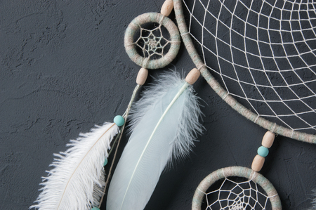 Mint cream dream catcher on gray textured background. Texture of concrete. の写真素材