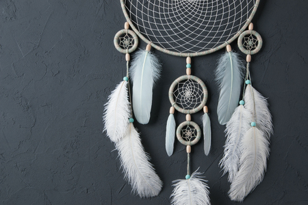 Mint cream dream catcher on gray textured background. Texture of concrete.の写真素材