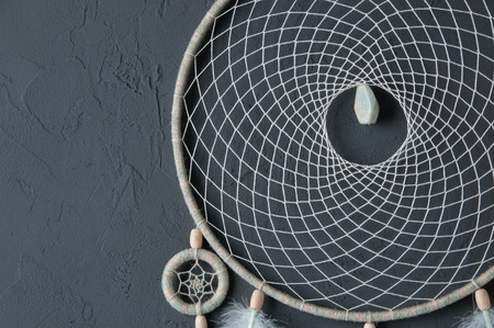 Mint cream dream catcher on gray textured background. Texture of concrete. の写真素材