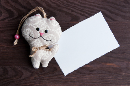 White blank note and toy on brown wooden background.Top view and copy space for textの写真素材