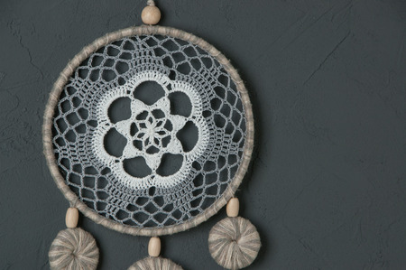 Gray white dream catcher on dark gray textured background. Texture of concrete, copy space for textの写真素材