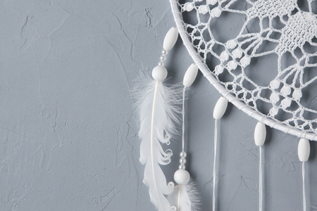 White crochet doily dream catcher close up on gray textured background. Texture of concrete, copy space for textの写真素材