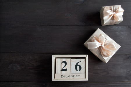 Boxing day sale and gift boxes on brown wooden backgroundの写真素材
