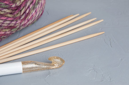 Multicolored yarn used for knitting clothes on gray textured background. Copy space for text.の写真素材