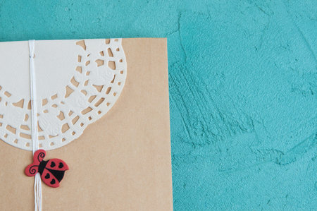 Gift kraft envelope on aquamarine textured background. Texture of concrete, copy space for textの写真素材