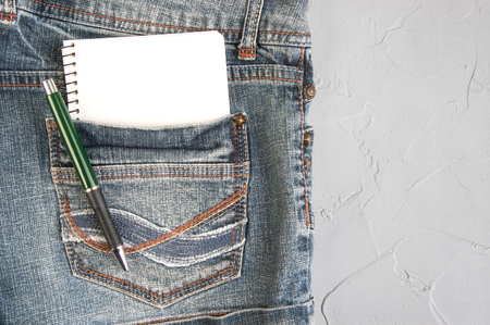 Notebook and pen in jeans pocket background. Copy space for textの写真素材