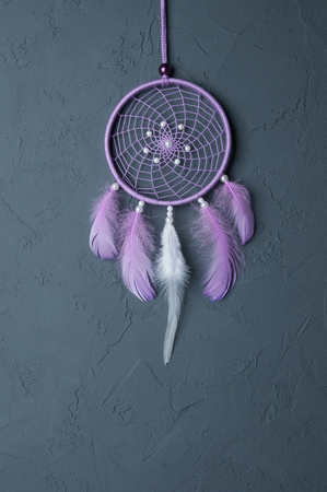 Lilac dream catcher on dark gray textured backgroundの写真素材