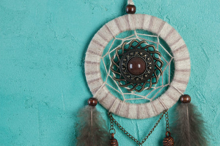 Beige brown dream catcher on aquamarine textured background. Texture of concreteの写真素材