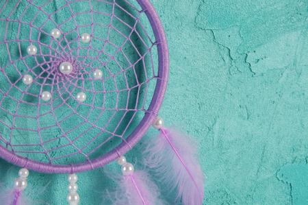 Lilac dream catcher on aquamarine textured backgroundの写真素材