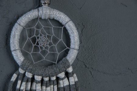 Gray dream catcher on dark gray textured background. Copy space for text.の写真素材