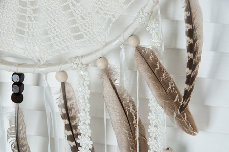 Cream crochet doily dream catcher close up on door background.の写真素材