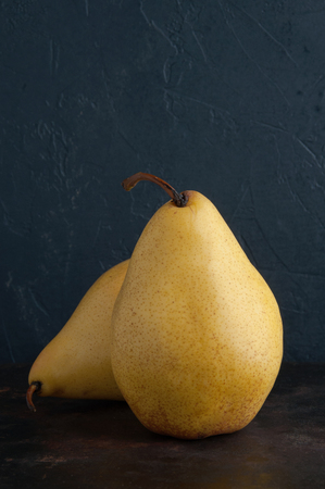 Two yellow pears on black backgroundの写真素材