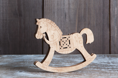 Wooden horse on brown wooden backgroundの写真素材