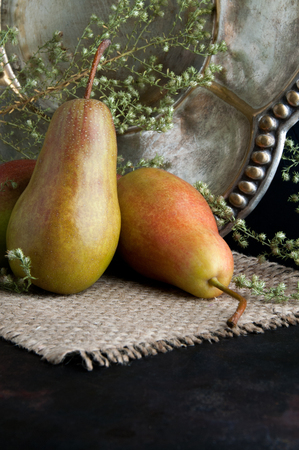 Pears and vintage plate on black backgroundの写真素材