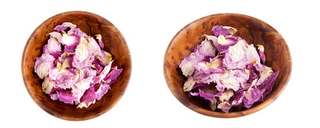 Dried rose petals in wooden bowl isolated on white background. Aroma decor.の写真素材