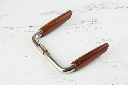 Vintage wooden metal door handle on shabby white wooden background. Copy space for text.の写真素材