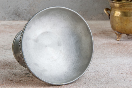 Vintage metal vase and green plants in brass and copper vintage flower pots on a concrete background. Copy space for text.の写真素材