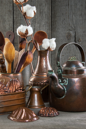 Vintage copper kitchen utensils on a wooden gray background. Props for food photography and copy space for text.の写真素材