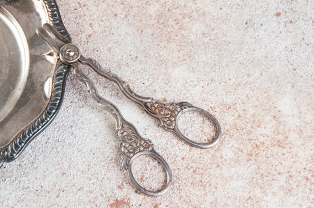 Vintage serving scissors for grapes on a concrete background. Copy cpace for text.の写真素材